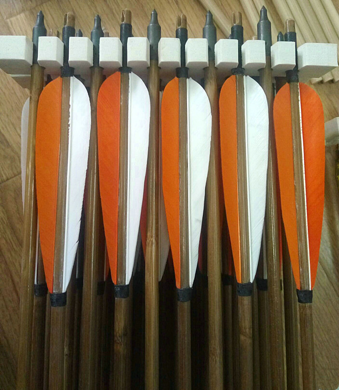 Orange and white feather with archery bamboo arrows